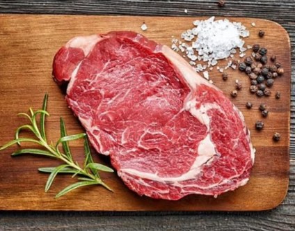 Raw ribeye steak on a cutting board